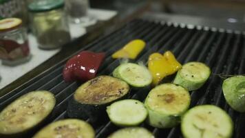 The chef puts chopped vegetables on the grill with his white-gloved hands video