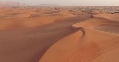 A drone flies over ATVs training in the desert sands in the UAE video