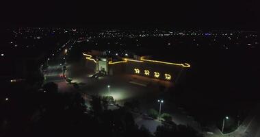 A drone flies at night over the illuminated main gate of the ancient complex Ark of Bukhara, Uzbekistan. video