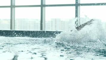 A young athletic man with a young son swims in the pool of an expensive luxury hotel. video