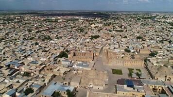 A drone flies over the architectural complex Poi-Kalon in old Bukhara, Uzbekistan. Cloudy cloudy day. video