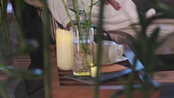 A guest of an expensive luxury hotel sits in an armchair in a bathrobe. Next to it is a table with utensils for tea drinking. video