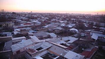 Sunrise over the one-story houses of the city. video