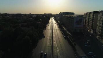 The drone flies over the roads and highways of the city with moving cars. Overcast summer day video