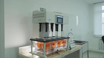 Scientific Automatic Mixer In Laboratory Mixes Chemical Components In Glassware. video