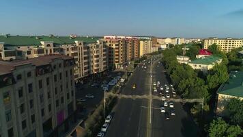 The drone flies over the roads and highways of the city with moving cars. Overcast summer day video