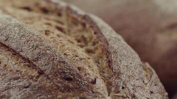 Camera is zoom through sliced and whole wheat bread and wheat ears to the clay pots video