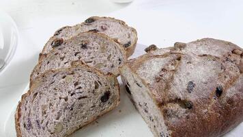 Close-up of sliced rye raisin bread on the white cutting board video