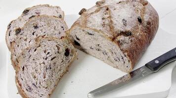 Close-up of sliced rye raisin bread on the white cutting board video