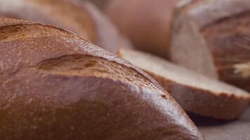 Camera is zoom through sliced and whole wheat bread and wheat ears to the clay pots video