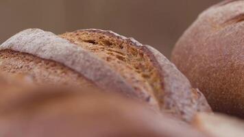 Camera is zoom through sliced and whole wheat bread and wheat ears to the clay pots video