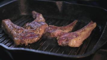 Still raw lamb ribs in spices are grilled video