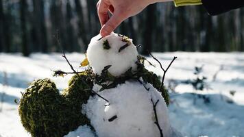 Hand completing creation of a snowman video