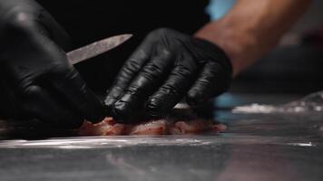 Hand of Cook is using biodegradable cling film for fish food video