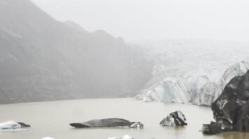 Freezing lake with ice melted near a glacier in iceland video