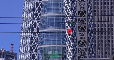 A moving crane at the top of the building at the business town in Tokyo telephoto shot video