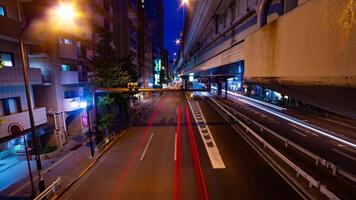 A night timelapse of the traffic jam at the city street under the highway wide shot tilt video