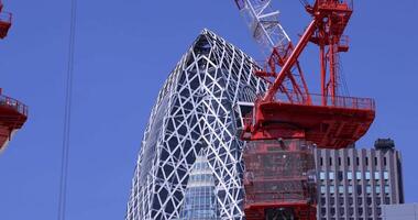 Stopping cranes at the top of the building at the business town in Tokyo telephoto shot video