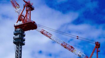 A timelapse of crane at the under construction in Tokyo telephoto shot zoom video