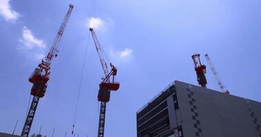 Moving cranes at the top of the building at the business town in Tokyo video