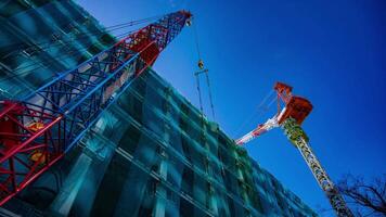 A timelapse of crane at the under construction in Tokyo low angle video