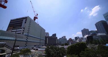 Cranes at the top of the building at the business town in Tokyo wide shot panning video