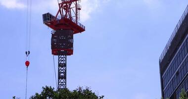 Stopping cranes at the top of the building at the business town in Tokyo telephoto shot video