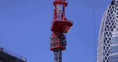 Stopping cranes at the top of the building at the business town in Tokyo telephoto shot video