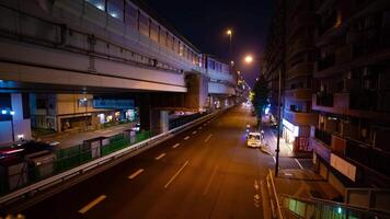 A night timelapse of the traffic jam at the city street under the highway wide shot zoom video