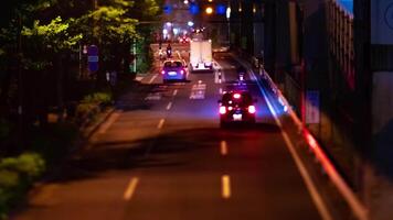 A night timelapse of the miniature traffic jam at the city street in Tokyo tilt video