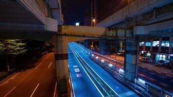A night timelapse of the traffic jam at the city street under the highway wide shot zoom video