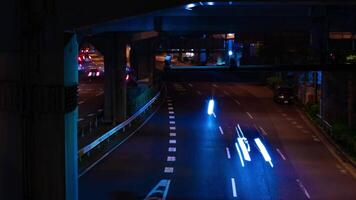 A night timelapse of the traffic jam at the city street under the highway in Tokyo zoom video