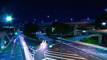 A night timelapse of traffic jam at the city intersection in Tokyo wide shot zoom video