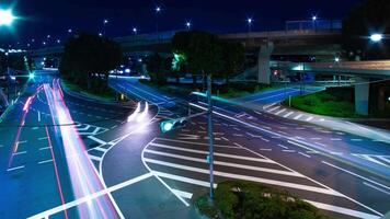 A night timelapse of traffic jam at the city intersection in Tokyo wide shot panning video