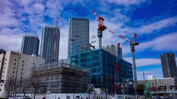 A timelapse of crane at the under construction in Tokyo wide shot tilt video