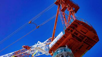 A timelapse of crane at the under construction in Tokyo telephoto shot tilt video