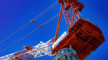 A timelapse of crane at the under construction in Tokyo telephoto shot video