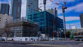 A timelapse of crane at the under construction in Tokyo wide shot panning video