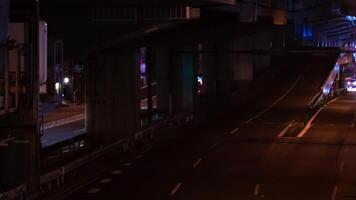 un noche lapso de tiempo de el tráfico mermelada a el ciudad calle debajo el autopista en tokio panorámica video