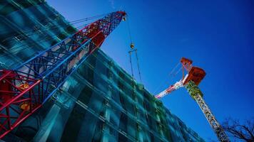 A timelapse of crane at the under construction in Tokyo low angle tilt video