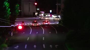 A night timelapse of miniature traffic jam at the city intersection panning video