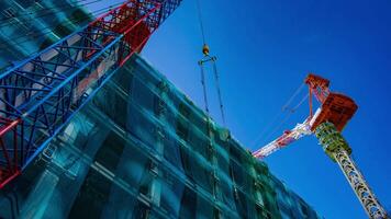 A timelapse of crane at the under construction in Tokyo low angle video