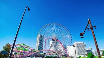 A timelapse of rolling ferris wheel in Yokohama wide shot panning video
