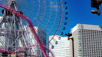 A timelapse of rolling ferris wheel in Yokohama telephoto shot tilt video