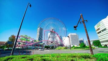 A timelapse of rolling ferris wheel in Yokohama wide shot tilt video
