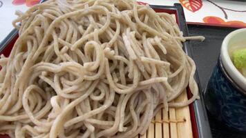 Soba noodle with sliced Japanese leek and wasabi at lunch top shot video