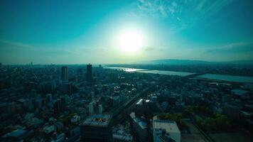 A sunset timelapse of panorama cityscape near Yodo river in Osaka wide shot tilt video