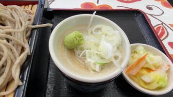 Soba noodle with sliced Japanese leek and wasabi at lunch top shot video