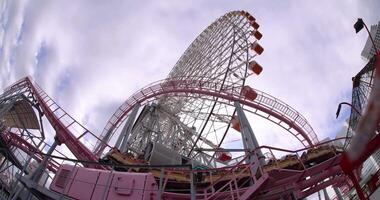 A rotating ferris wheel behind the sky in Yokohama fish eye shot video