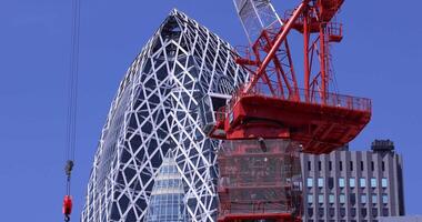 Stopping cranes at the top of the building at the business town in Tokyo telephoto shot video